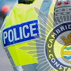 Pictured: Cambridgeshire Police crest with a high-vis police vest. 