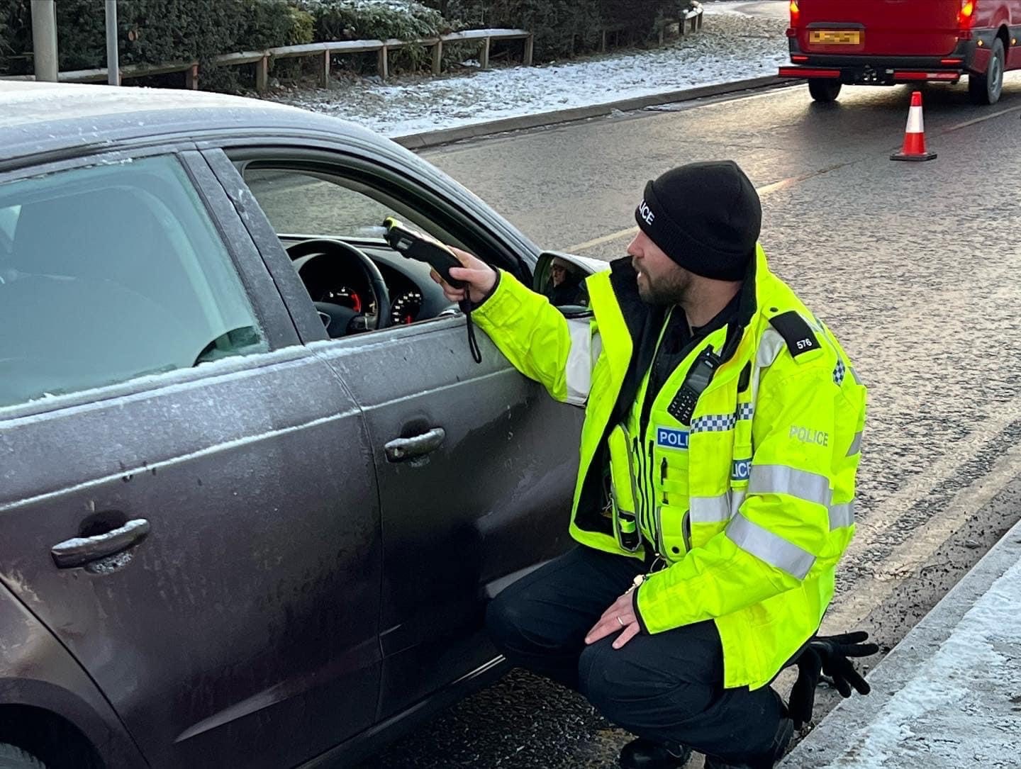 A driver taking a roadside breath test in Huntingdon