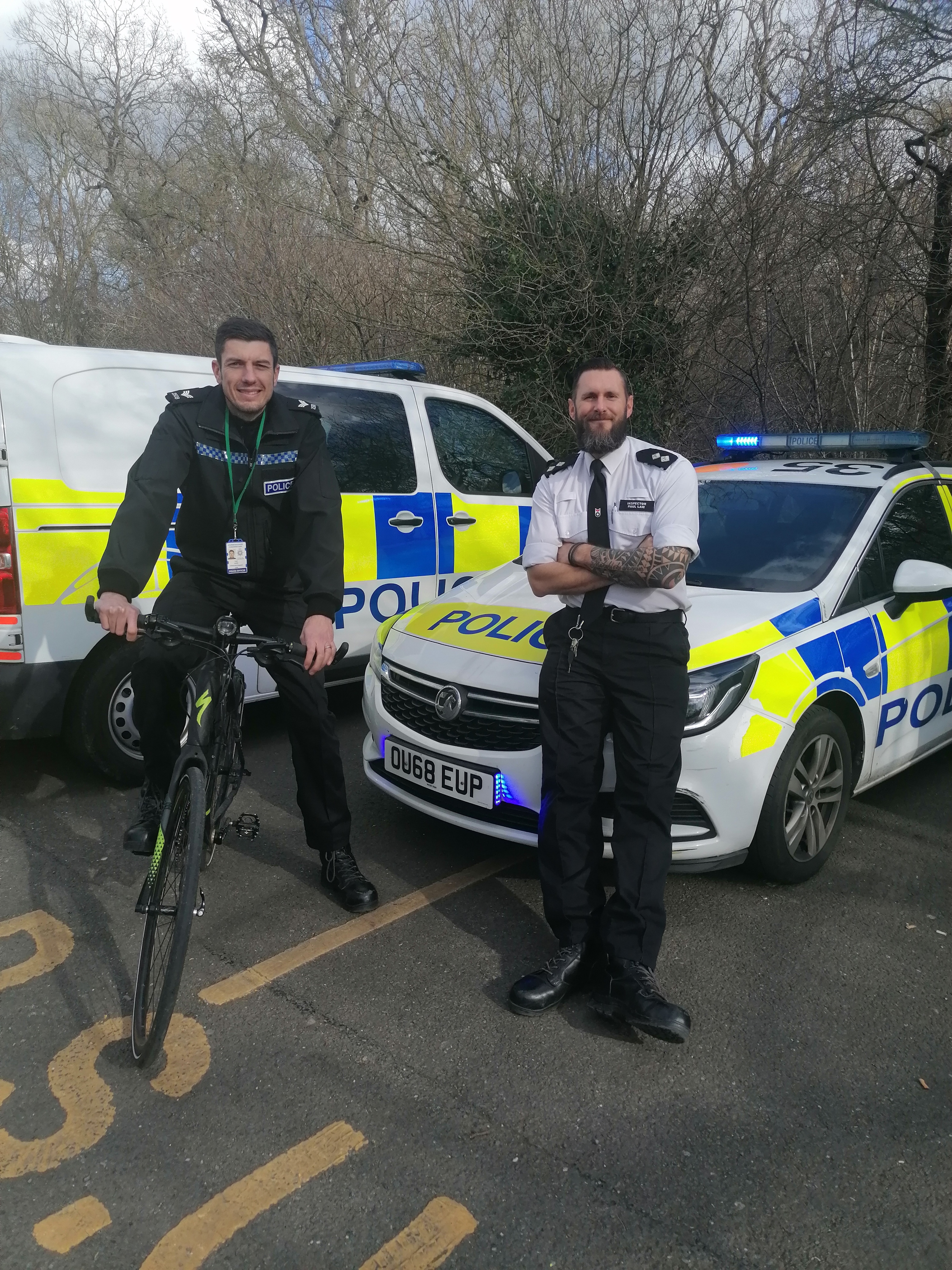 Scott and Paul standing in front of police car
