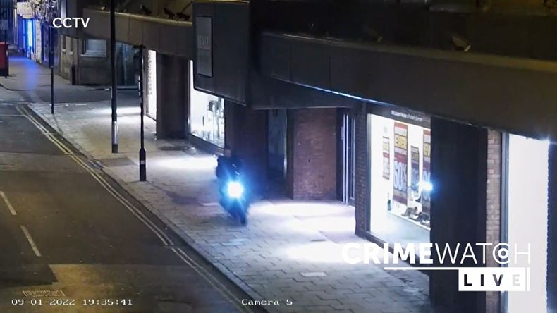 Still from CCTV footage showing a moped riding on a path with Crimewatch Live text overlaid