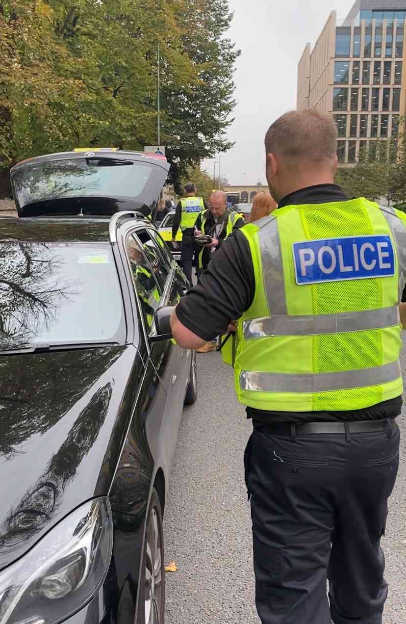 Police officer checking taxi 