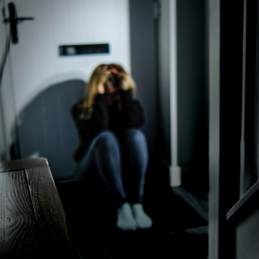 A woman behind a door