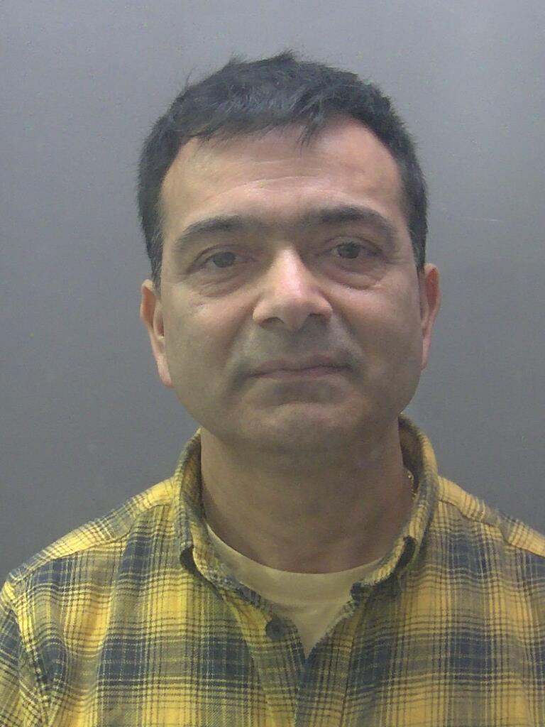 Custody photo of Pramod Dhakal