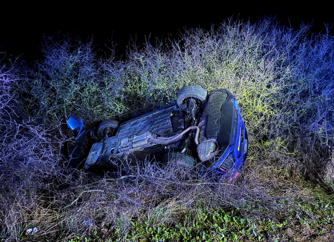 Car upside down on the roadside