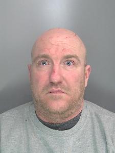 A custody photo of a bald man. 