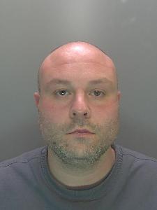 A custody photo of a bald man. 