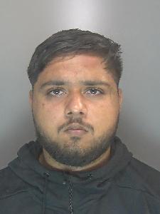A custody photo of a man looking glum. 