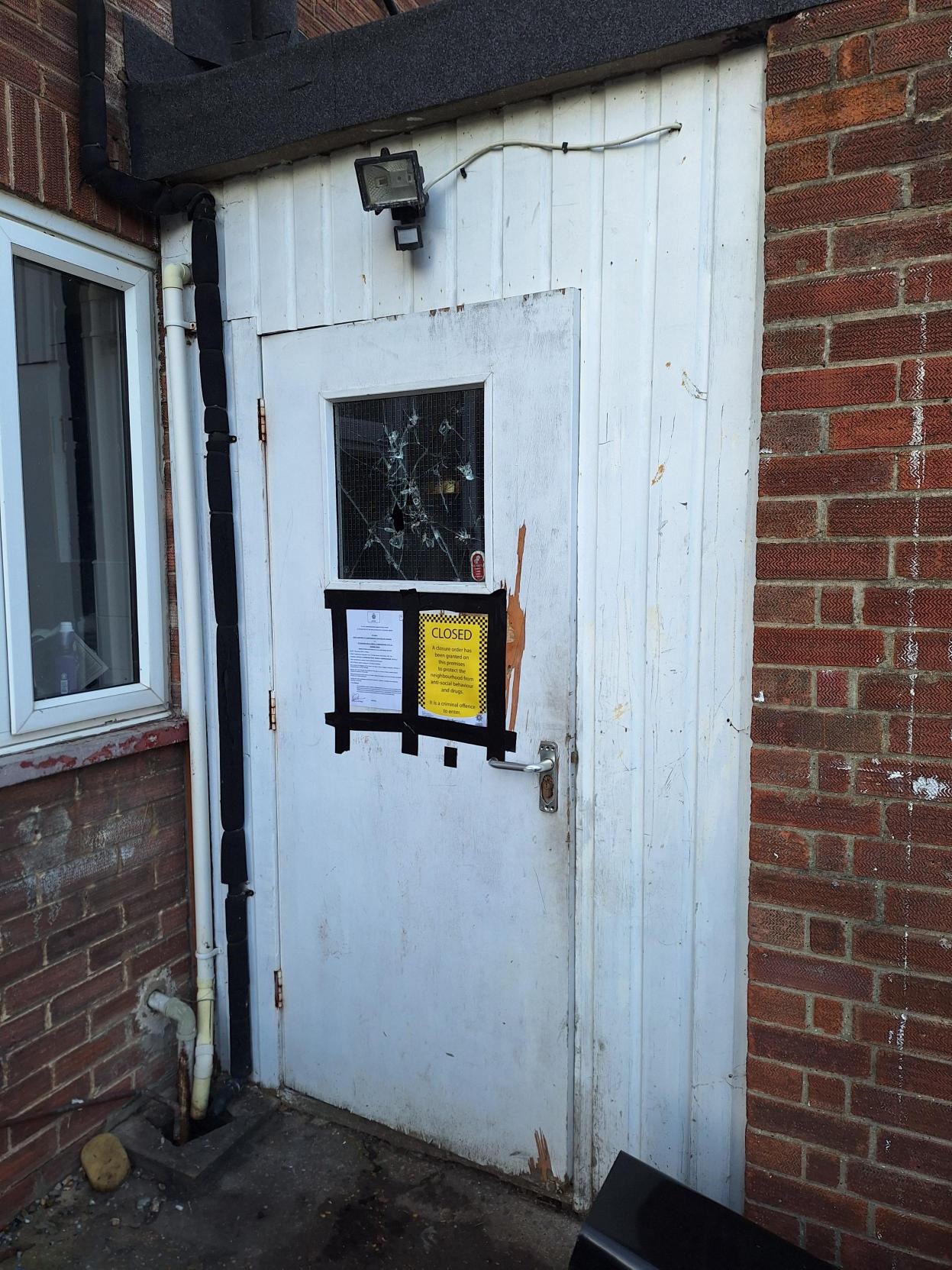 Closure order signs taped to a white door