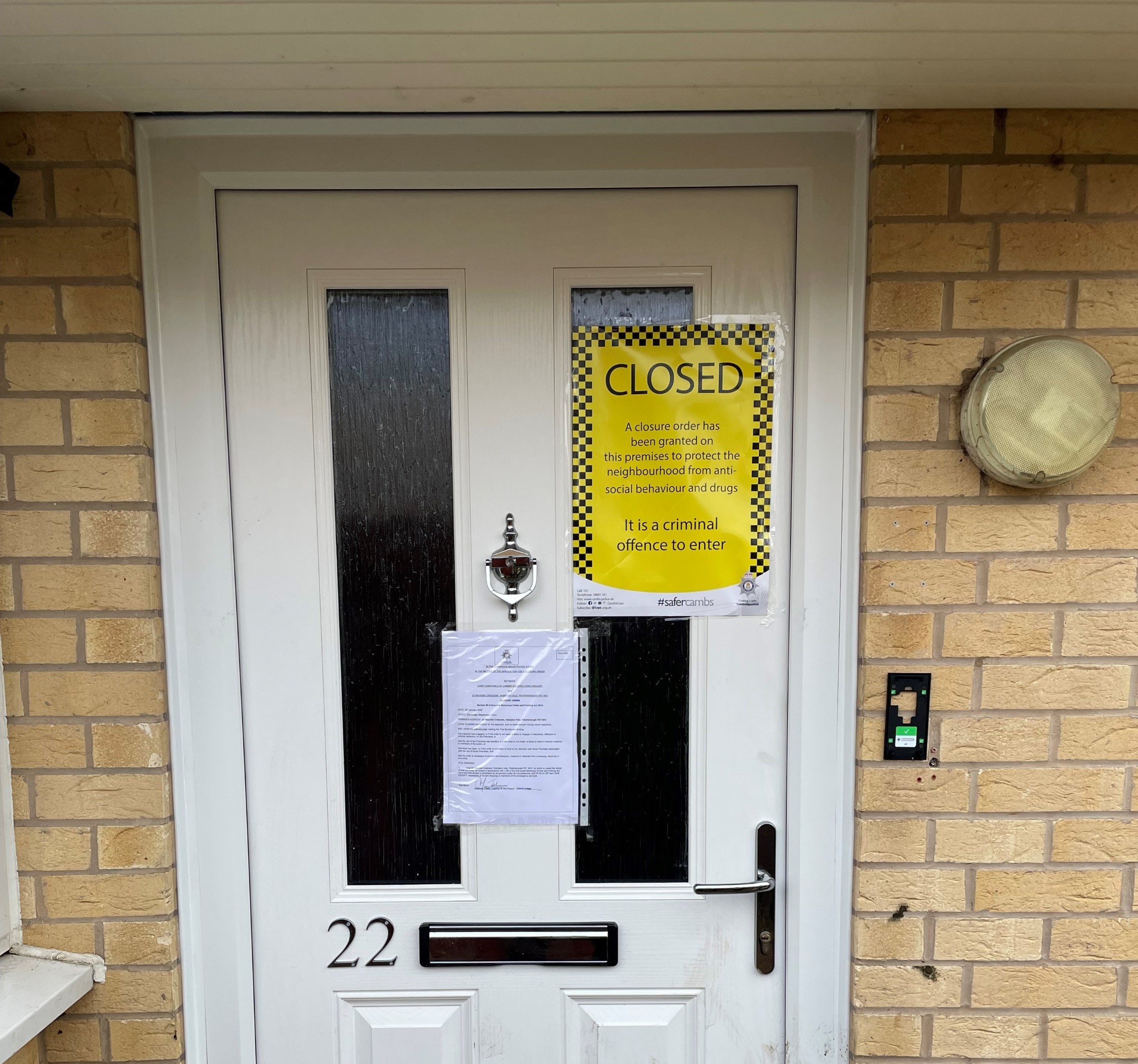 Closure order signs on a front door