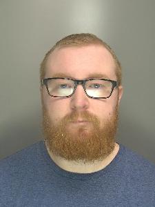A custody photo of a ginger man. 