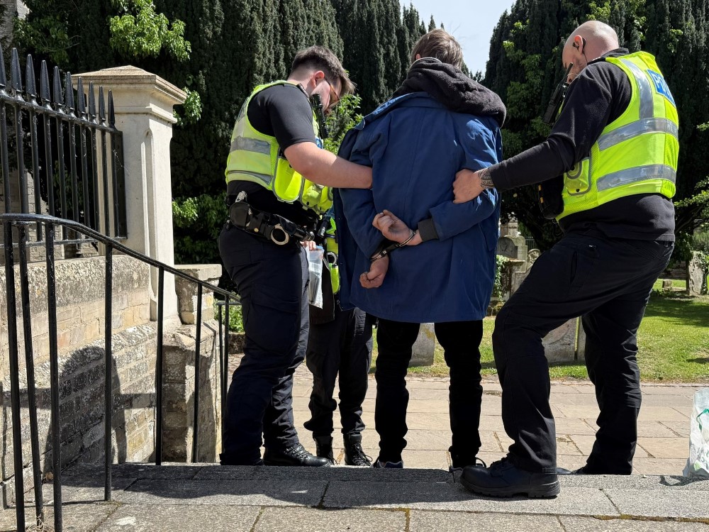 Man being arrested by two police officers