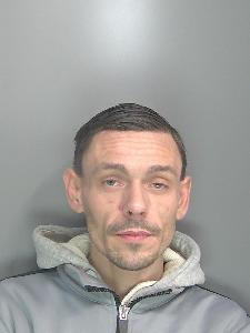 A custody photo of a dishevelled man. 