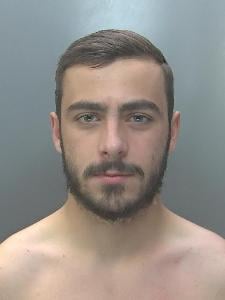 A custody photo of a man with no top on. 
