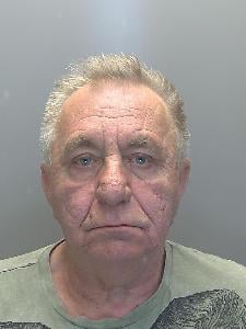 A photo of a man looking glum. 