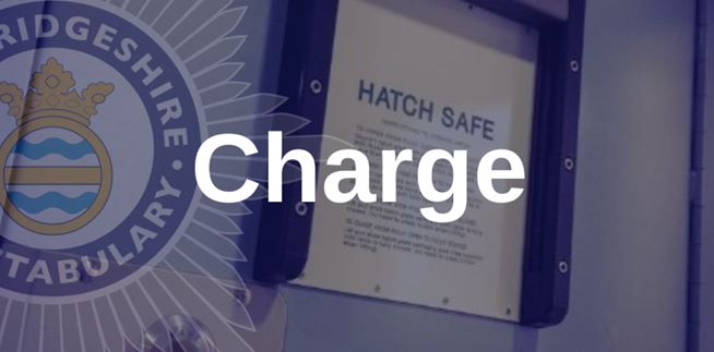 Close up of police custody cell hatch with charge text overlaid
