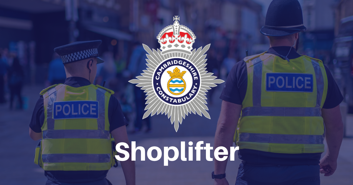 Two police officers walking down the street with the force crest and word shoplifter in the foreground